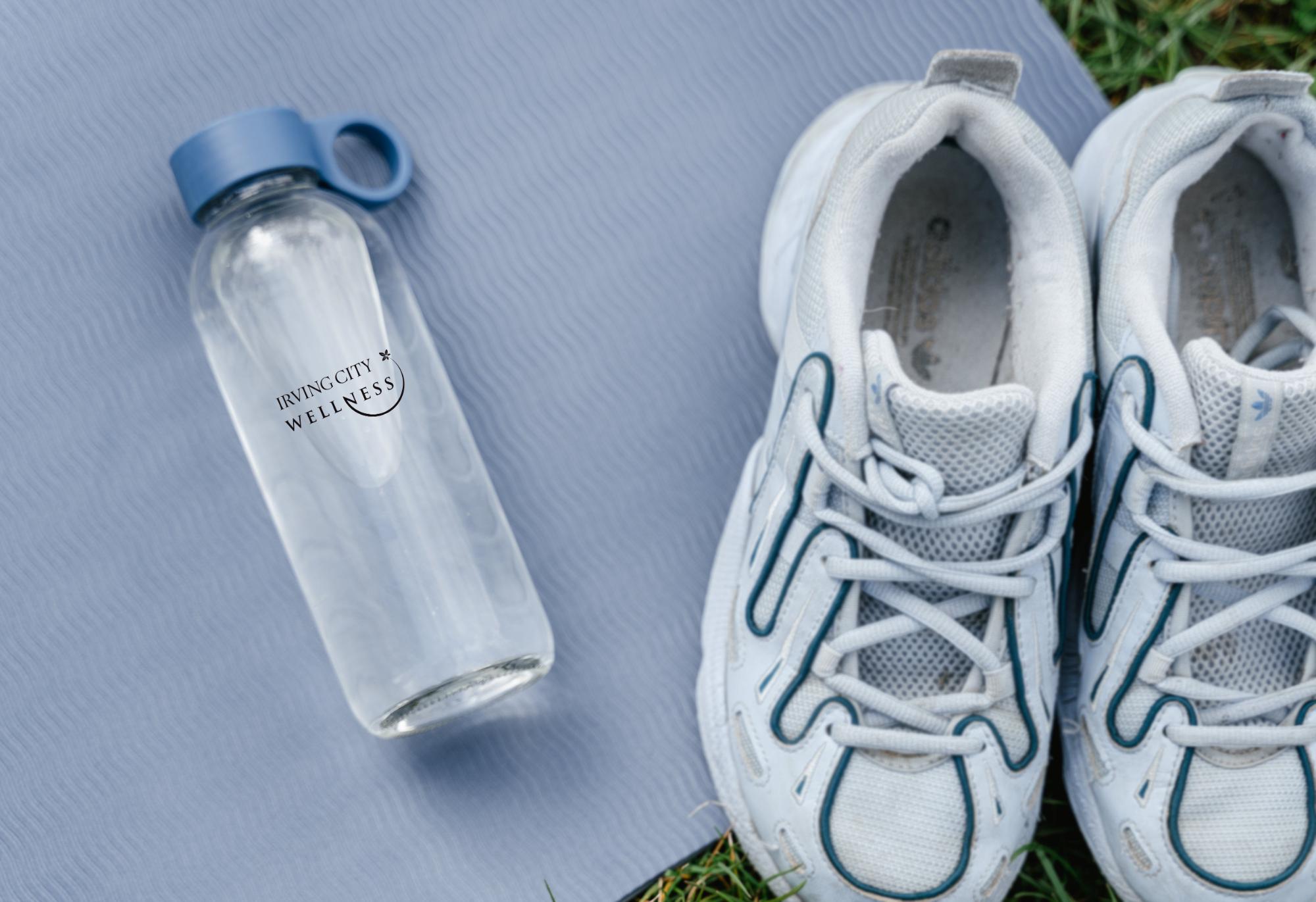 an imprinted water bottle and sneakers